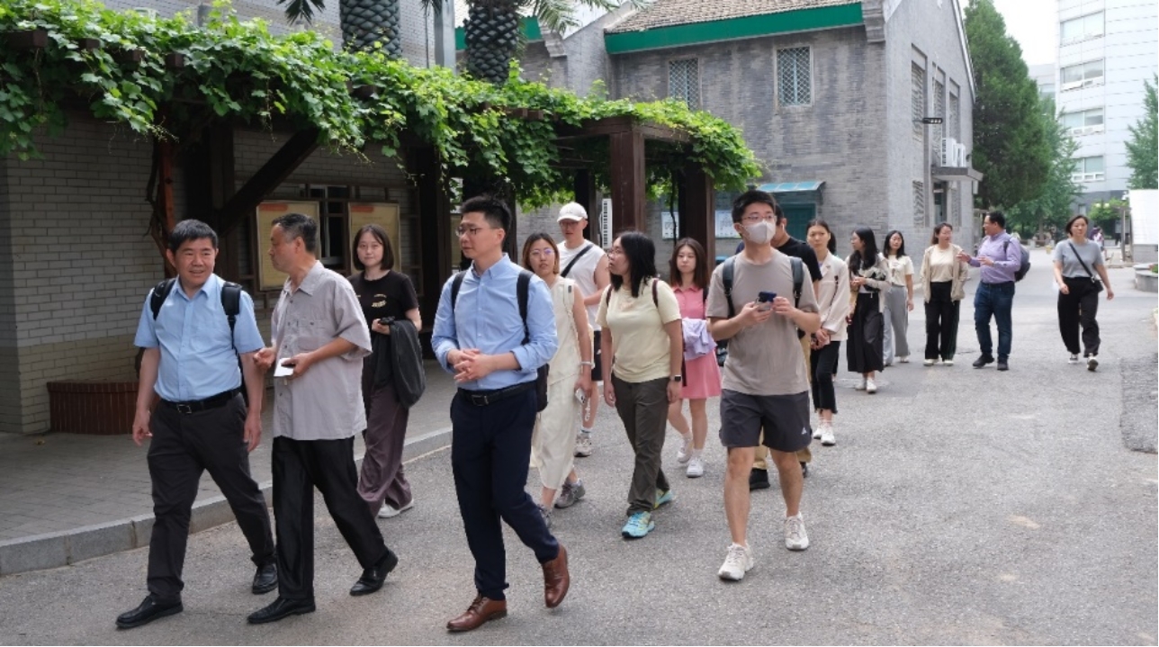 A group of people walking on a street

Description automatically generated